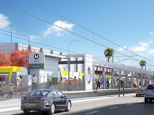 Rendering of a modern light rail station with platforms, shelters, overhead catenary, and passengers boarding trains in an urban corridor.